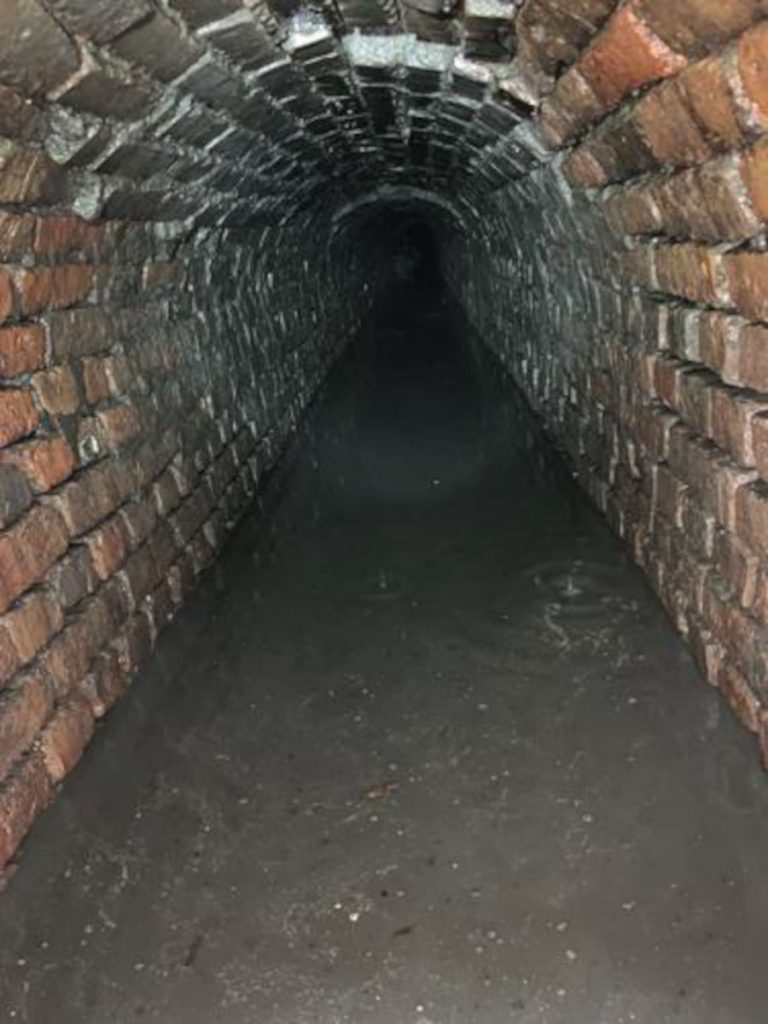 The interior of a brick arch drainage tunnel in Charleston