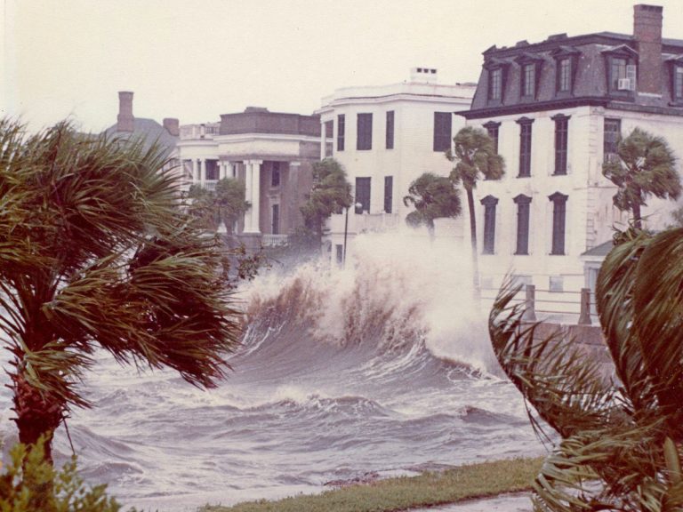 Homes on the East Battery in Charleston as storm surge waves from Hurricane Hugo crest over the seawall