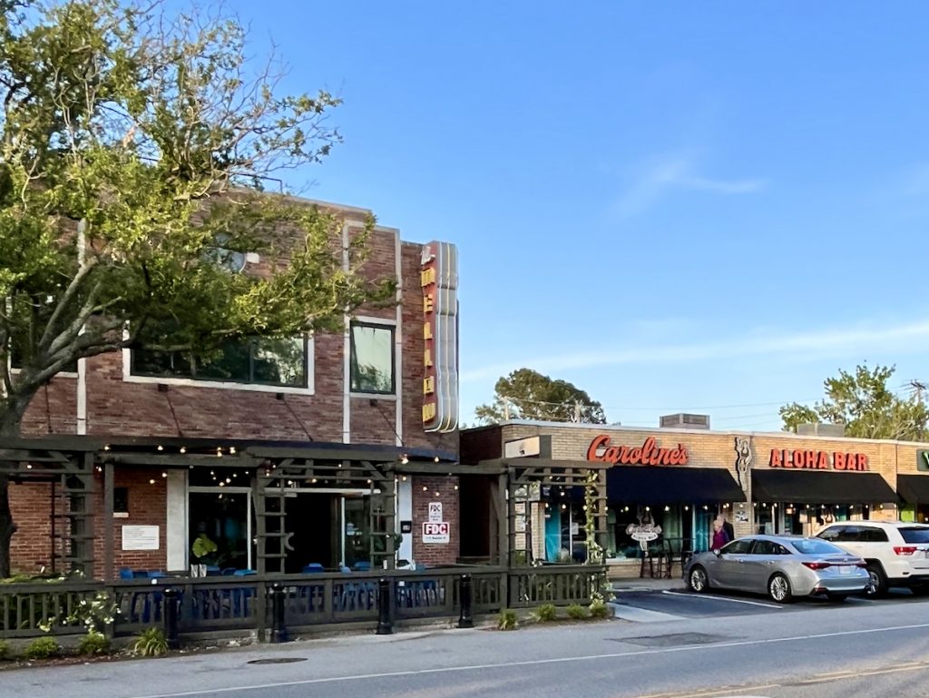 Shops and restaurants in the village of Avondale with cars parked out front
