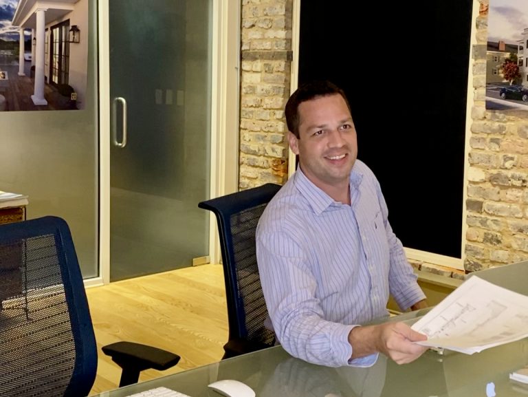 A photo of Bryan McElveen working with documents in a real estate office of Dunes Properties of Charleston